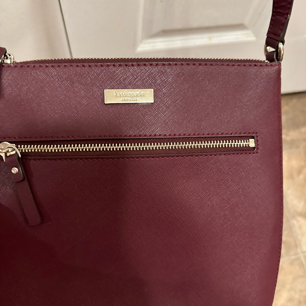 Kate Spade bag- Burgandy. Zipper front, inside pocket and zipper.Burgundy